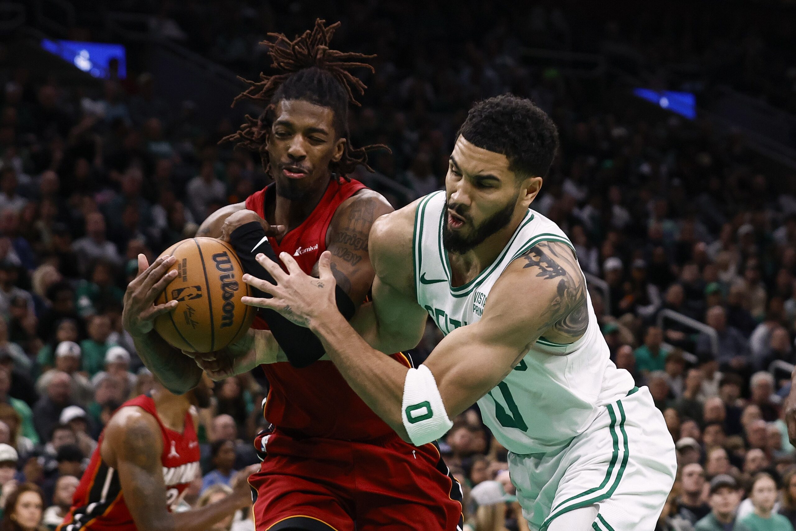 Jayson Tatum of the Boston Celtics battles Delon Wright of the Miami Heat