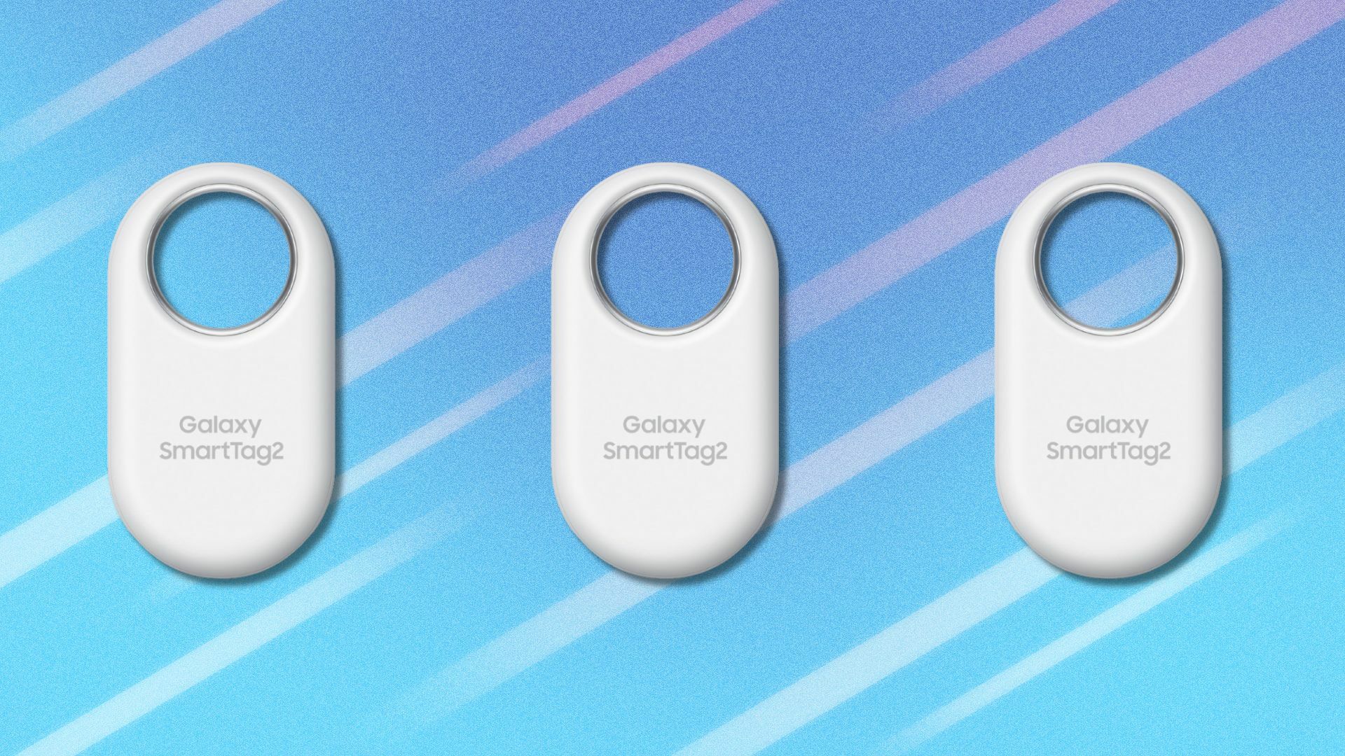 three white SAMSUNG Galaxy SmartTag2 bluetooth trackers on a light blue background that has white streaks running across it
