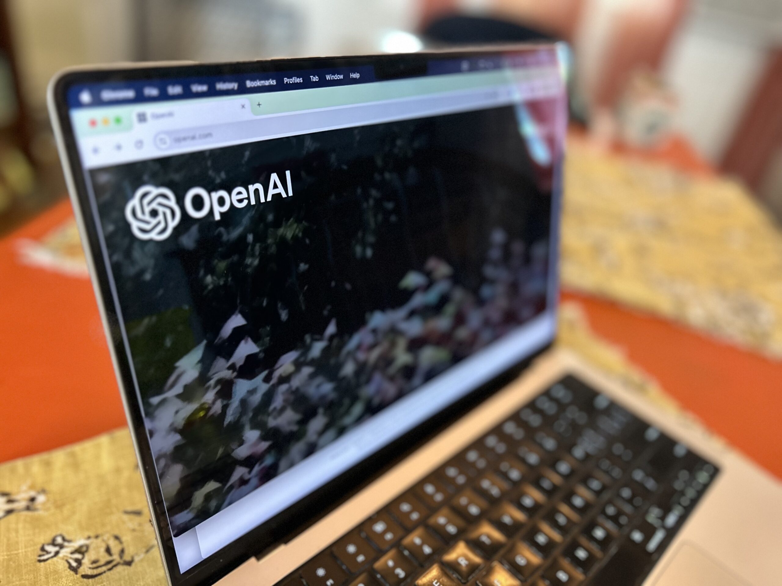 a laptop displaying the OpenAI website