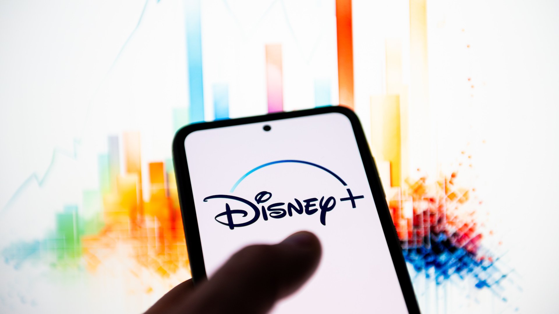 In this photo illustration a Disney + logo is seen displayed on a smartphone. 