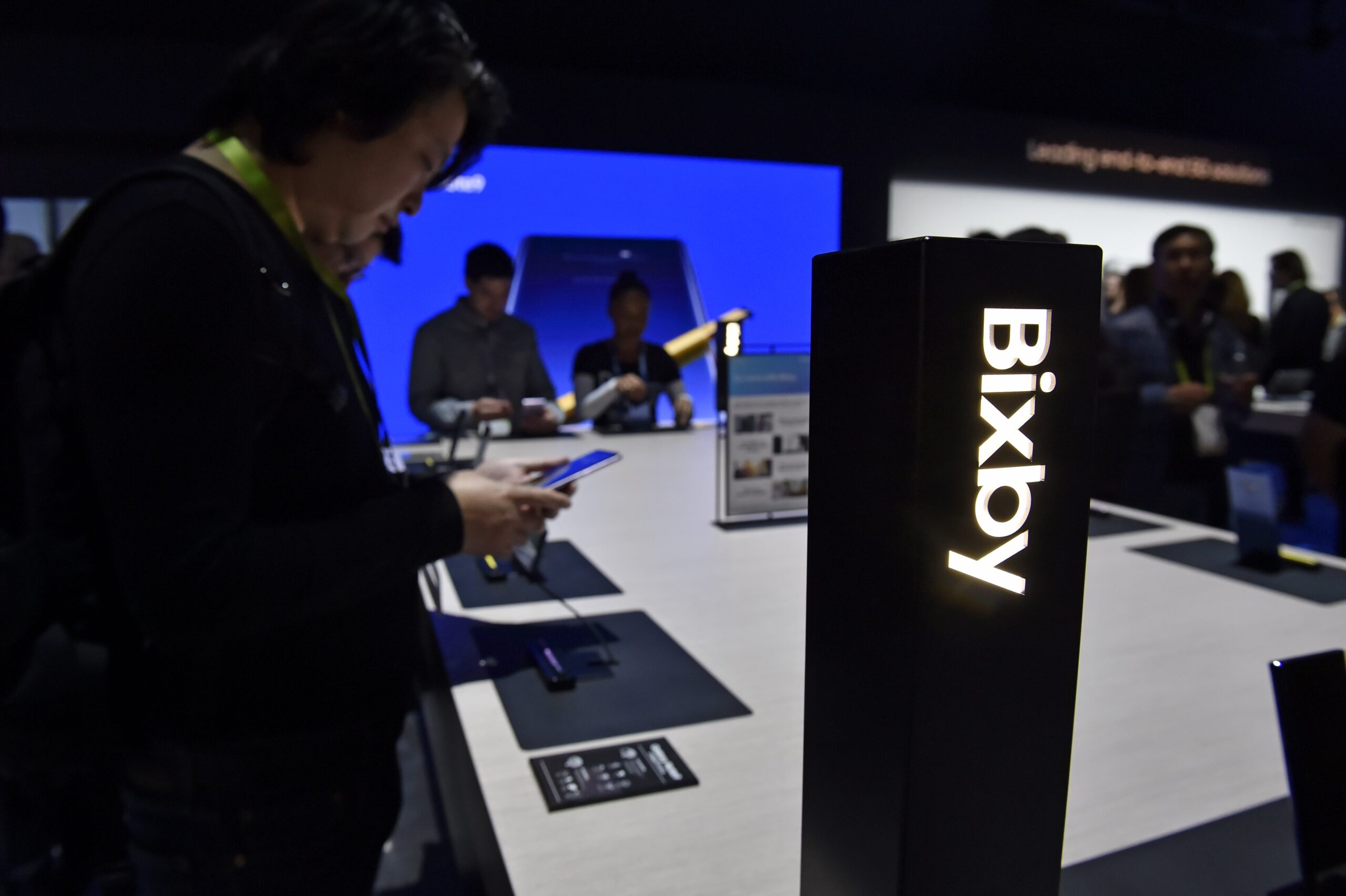 Attendees examine Bixby enabled devices at the Samsung booth during CES 2019 at the Las Vegas Convention Center
