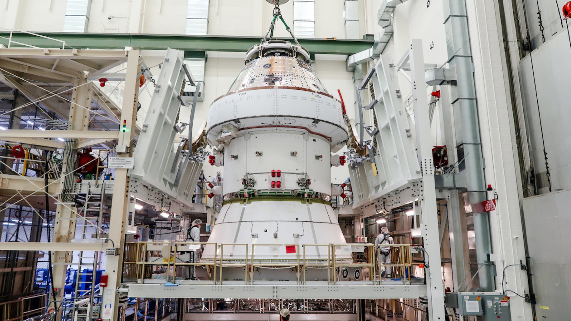 The stacked Orion vehicle. At bottom are engineers, for size reference.