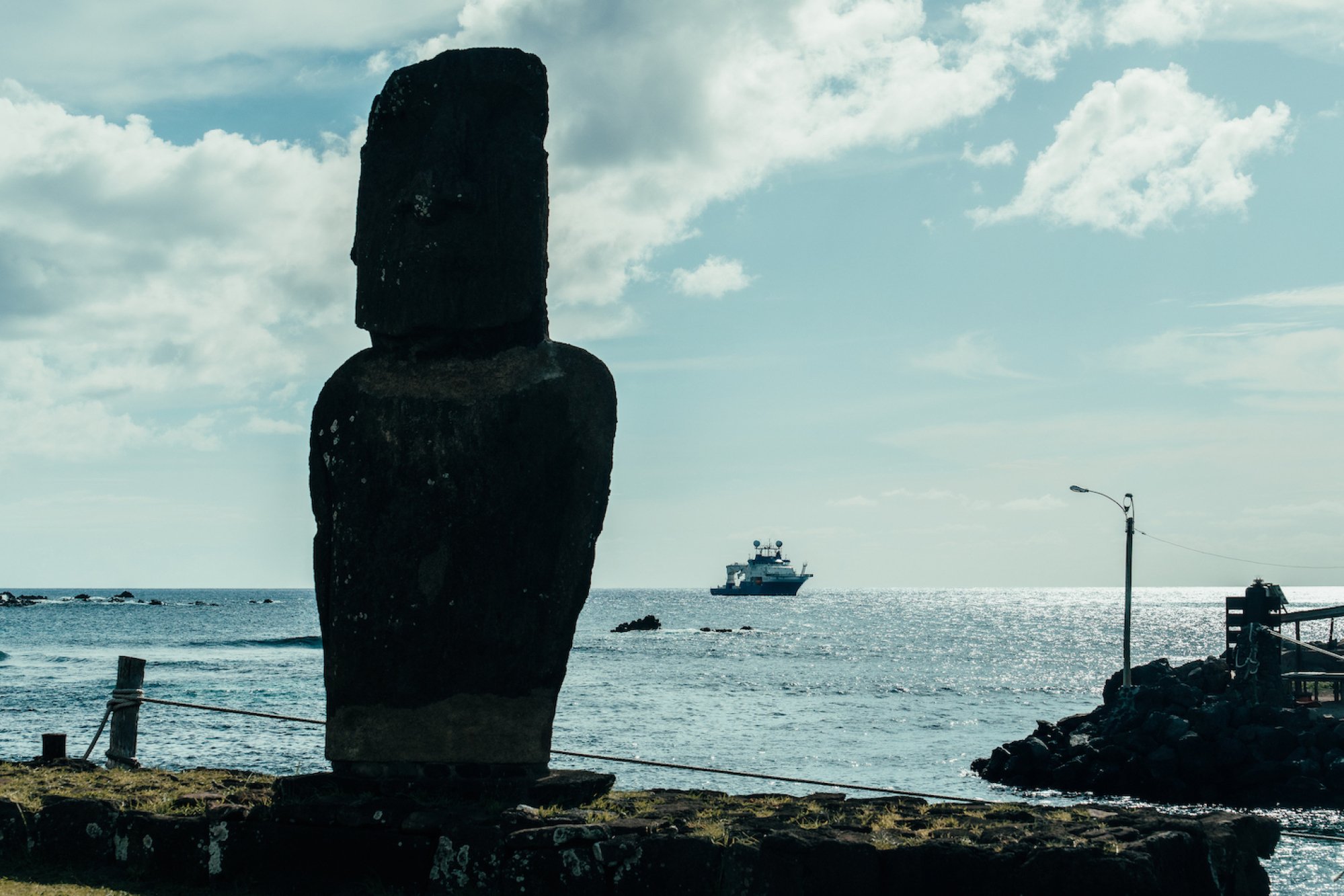 A moai on Rapa Nui (Easter Island), with the exploration vessel RV Falkor (too) in the background.