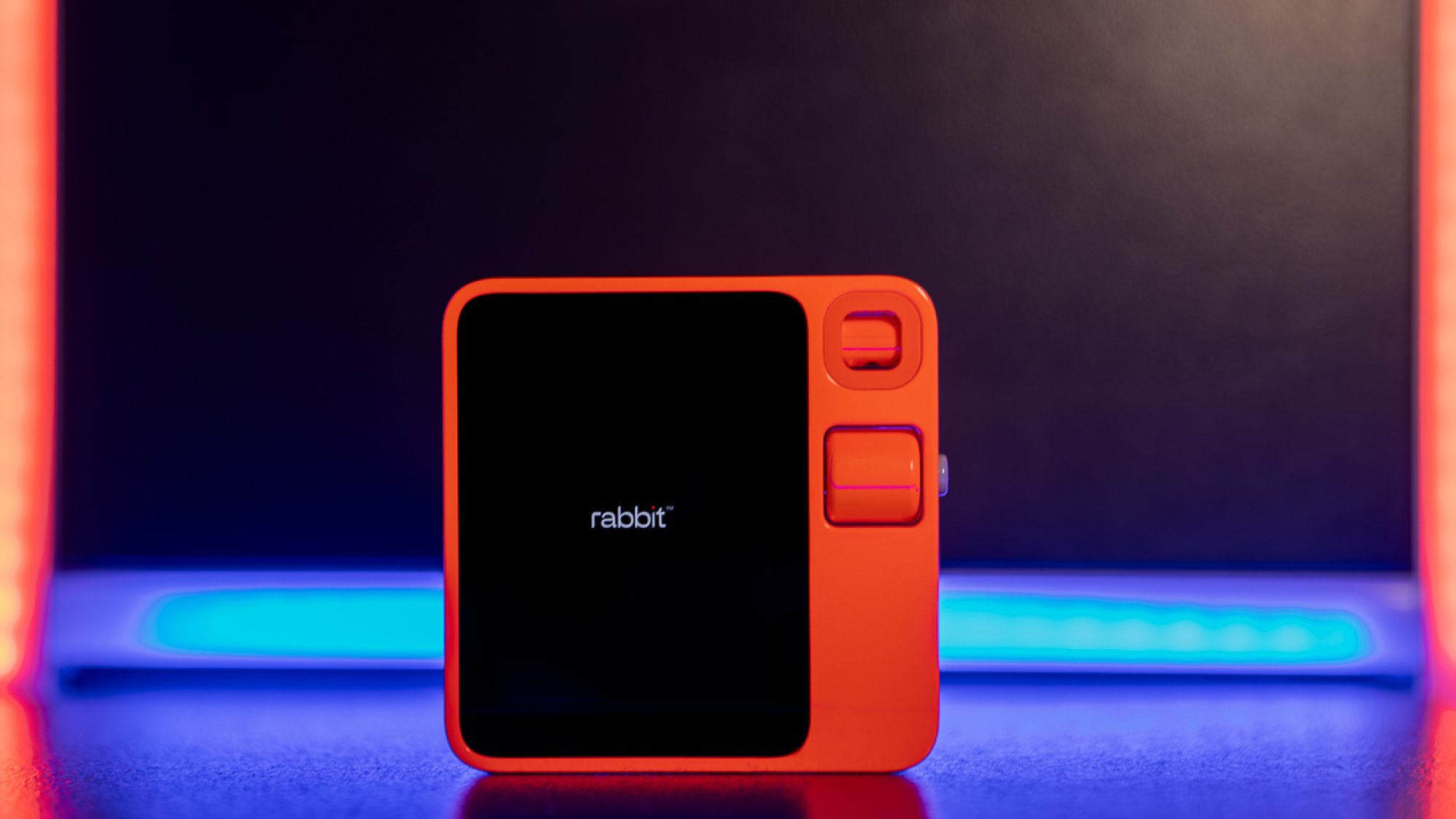 Rabbit R1 on a neon-lit platform