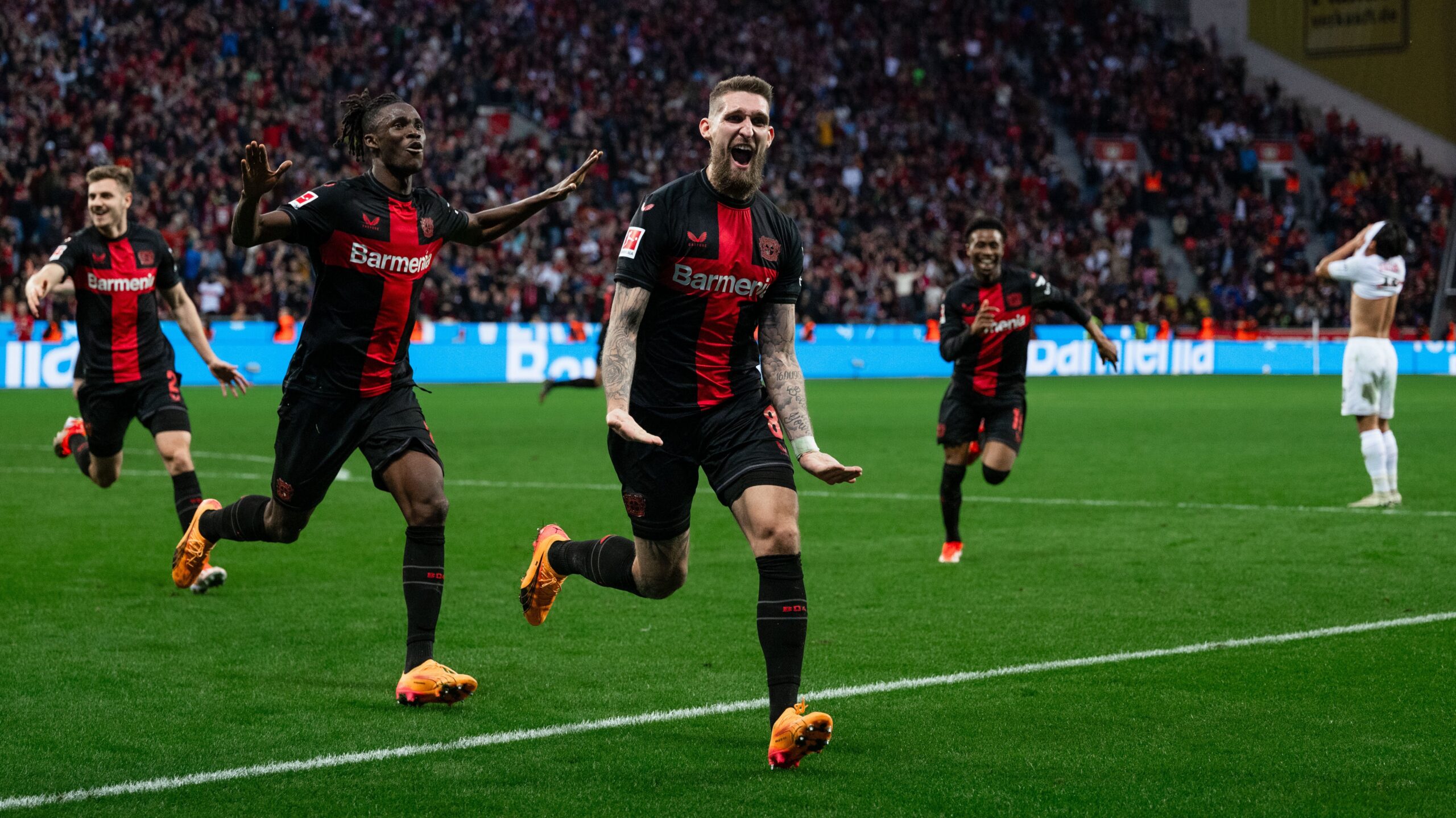 Leverkusen's Josip Stanisic, Odilon Kossounou and goalscorer Robert Andrich celebrate