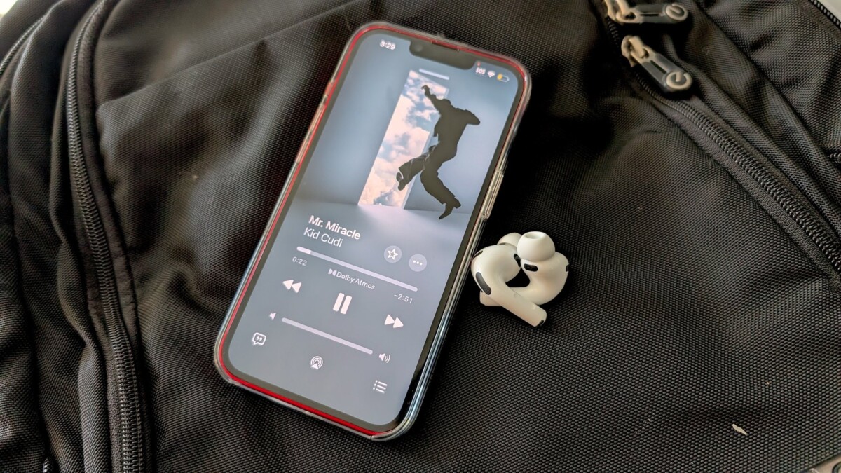 The Apple AirPods Pro 3 next to a phone playing music