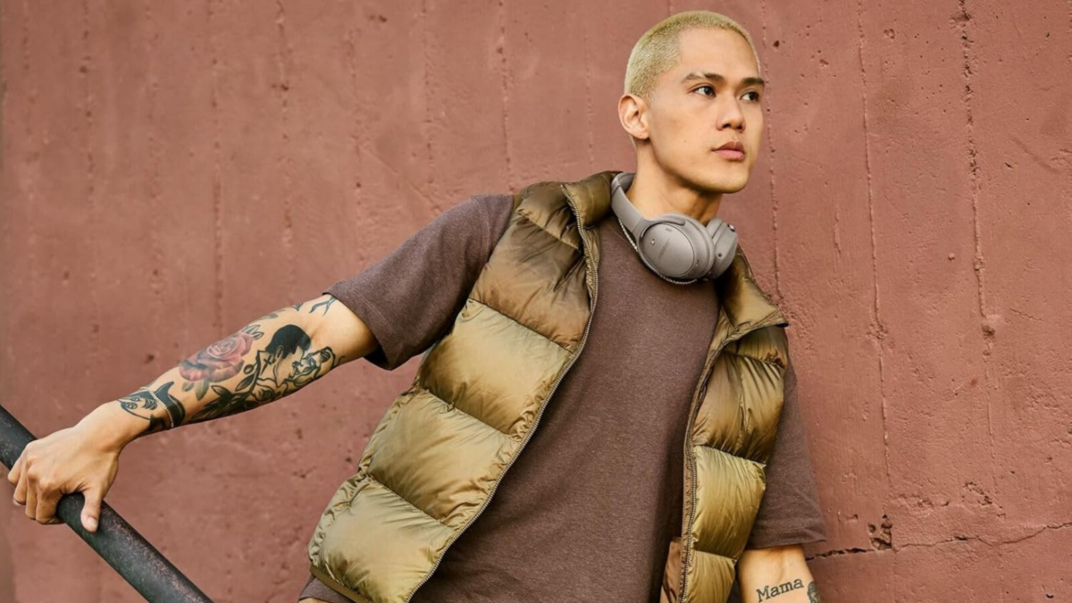 man wearing bose quietcomfort headphones around his neck