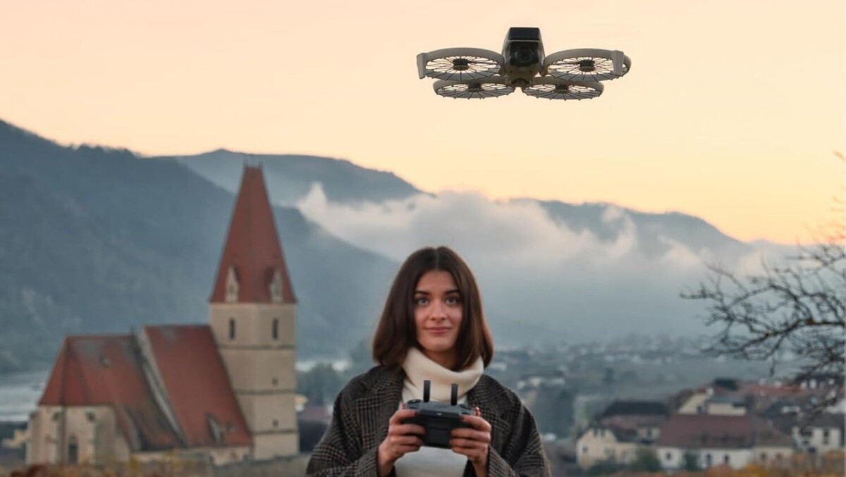 a person operated the DJI Flip drone with the RC 2 while an old castle sits in the background with mountains