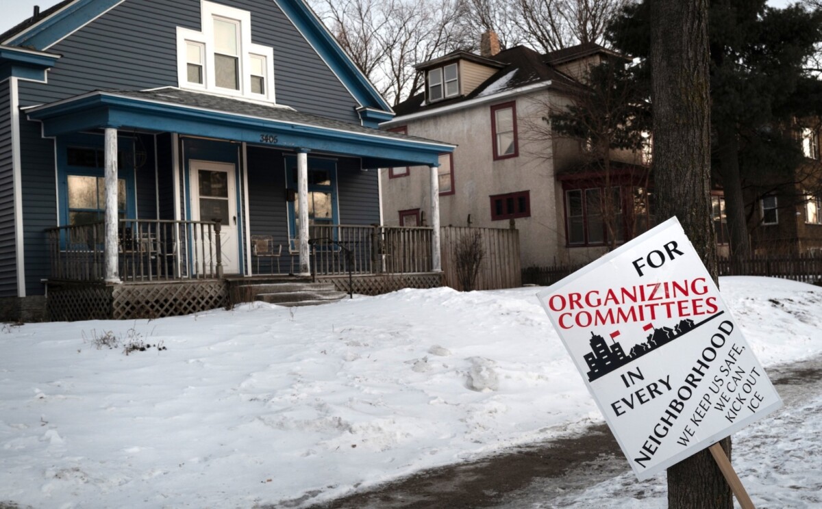 An ICE resistance organizing sign sits in front of a home